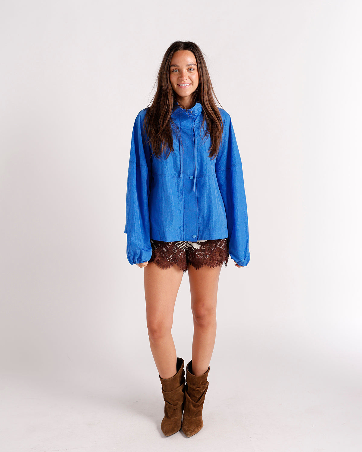 Oversized royal blue windbreaker jacket with drawstring hood and snap buttons