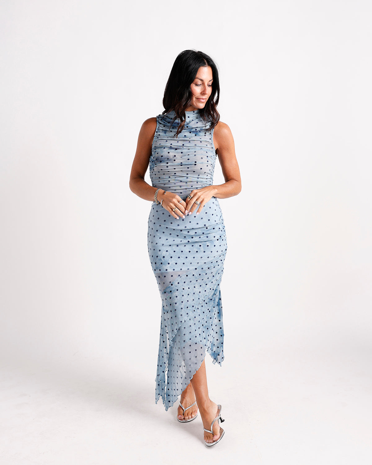Blue polka dot ruched mesh midi dress with high neck and asymmetric hem