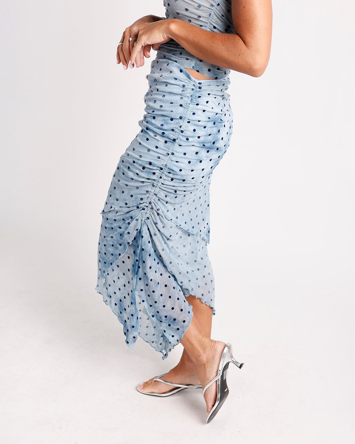 Blue polka dot ruched midi skirt with asymmetric hem and side cutout detail