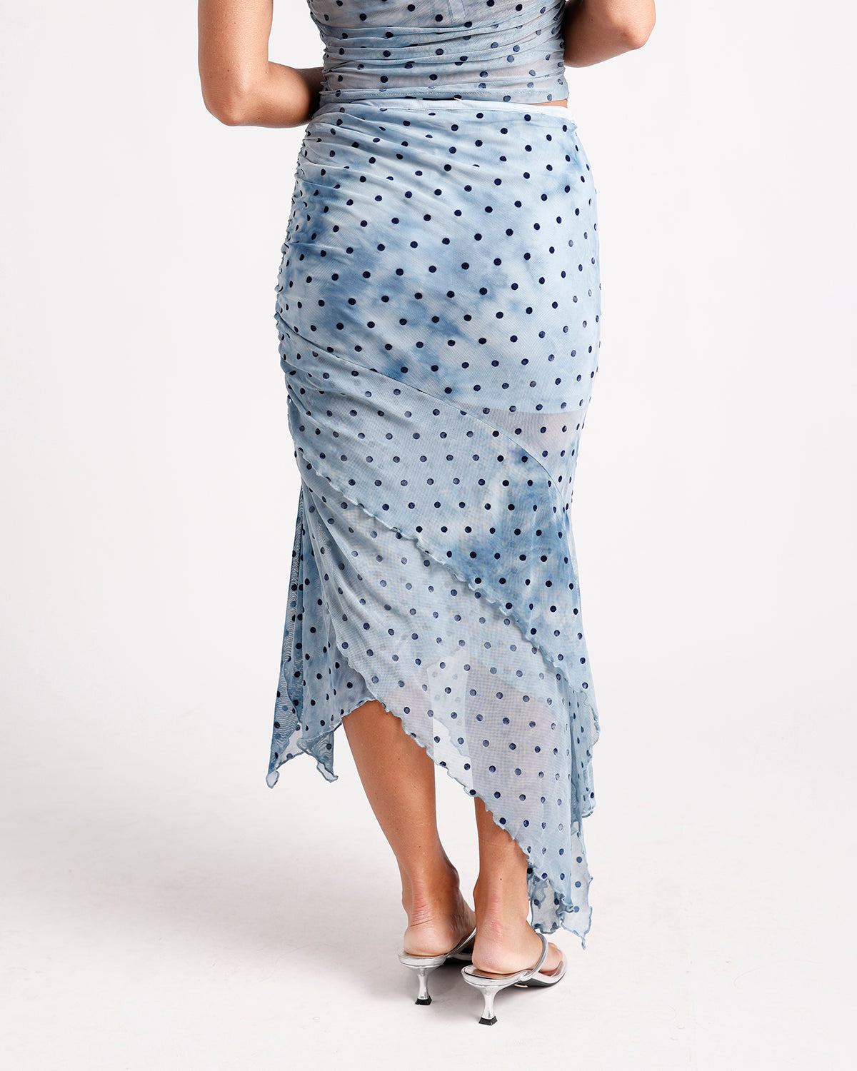 Light blue polka dot ruched mesh midi skirt with asymmetric hem, back view