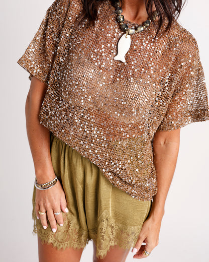Bronze sequin mesh short-sleeve top styled with olive lace-trim shorts