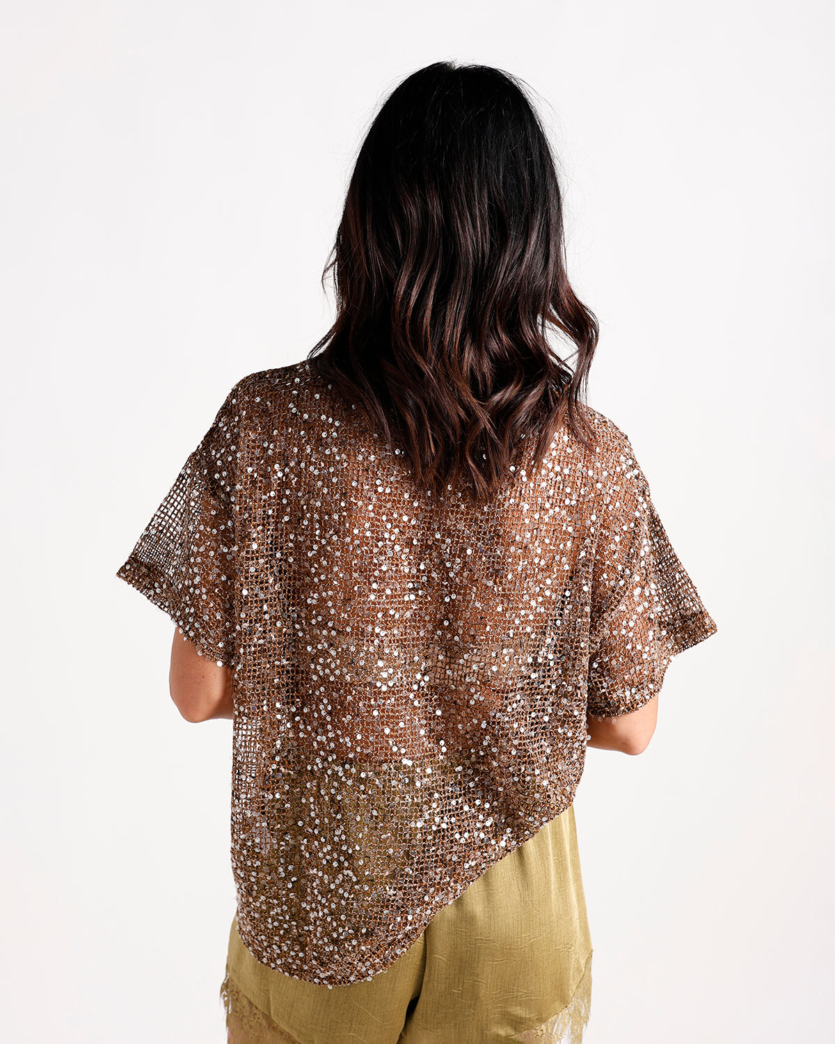 Bronze sequin mesh short-sleeve top, back view, worn over olive pants