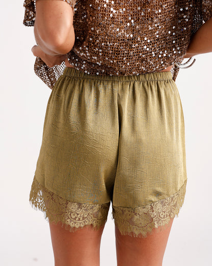 Olive green satin shorts with lace trim hem and elastic waistband