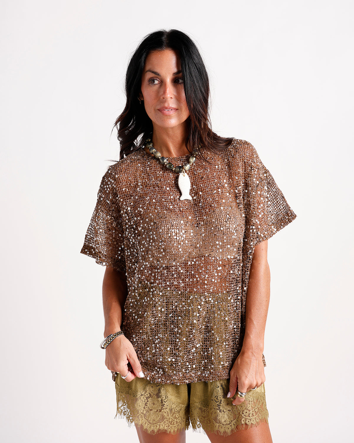 Olive green lace shorts with scalloped hem, worn with bronze sequin top