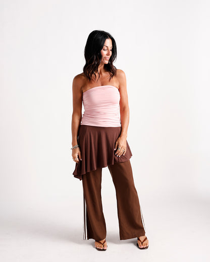 Brown wrap dress with ruffle hem and stripe detail, styled over wide-leg pants