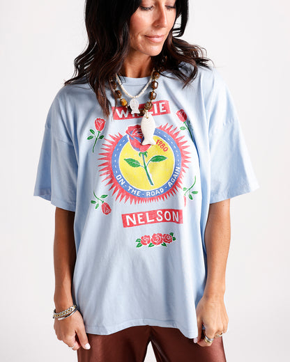 Light blue oversized graphic tee with rose print and 1980 retro band design