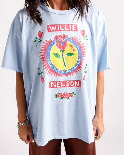 Light blue oversized graphic tee with Willie Nelson 1980 rose print design
