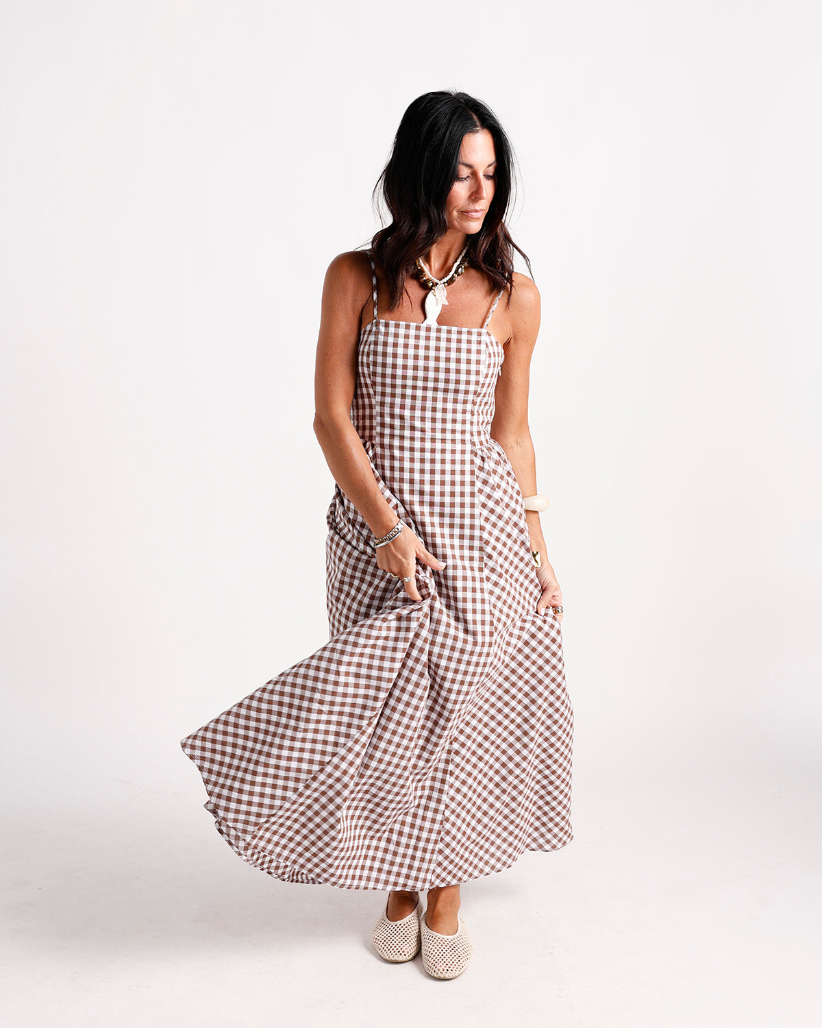 Brown and white gingham maxi dress with spaghetti straps and flowing skirt