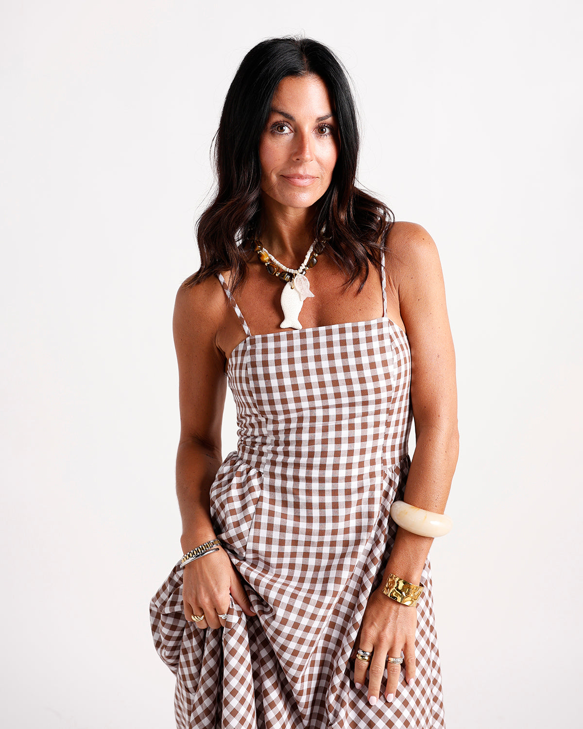 Brown and white gingham maxi dress with thin straps and ruched waist