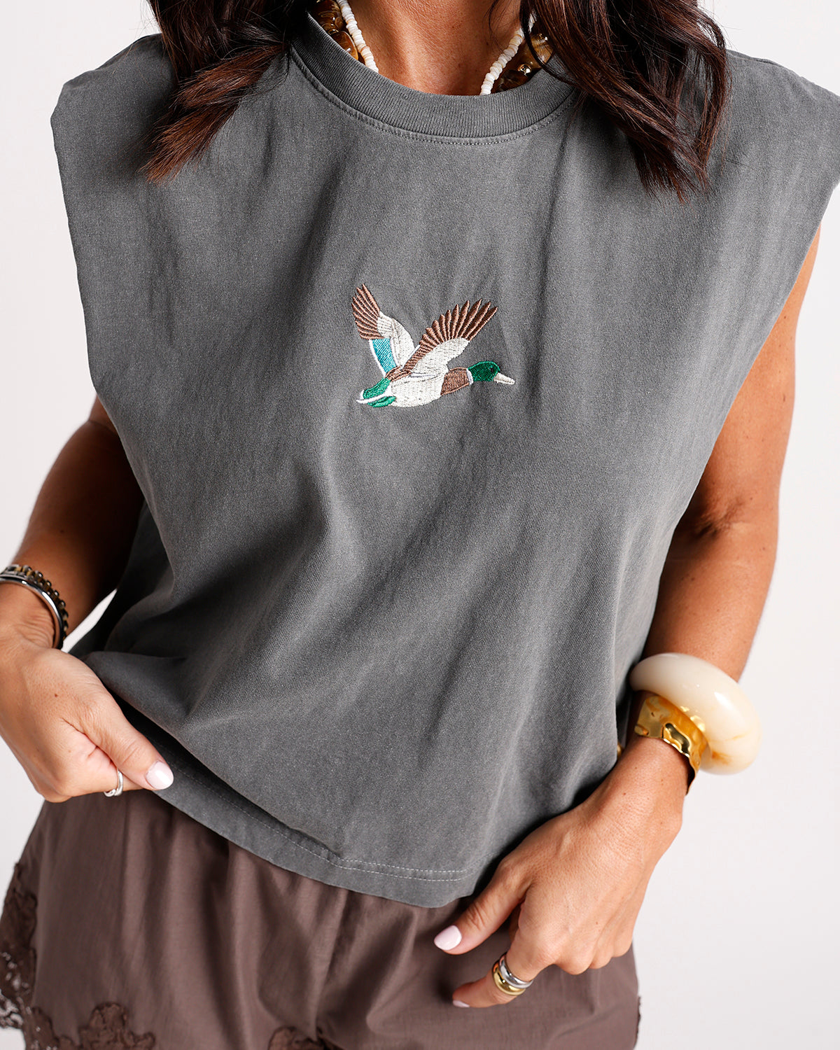 embrace effortless style with this olive brown cropped tee featuring a beautifully embroidered mallard duck detail, relaxed fit, and classic crew neckline. the perfect casual graphic tee for everyday outfits, weekend adventures, and nature-inspired style.