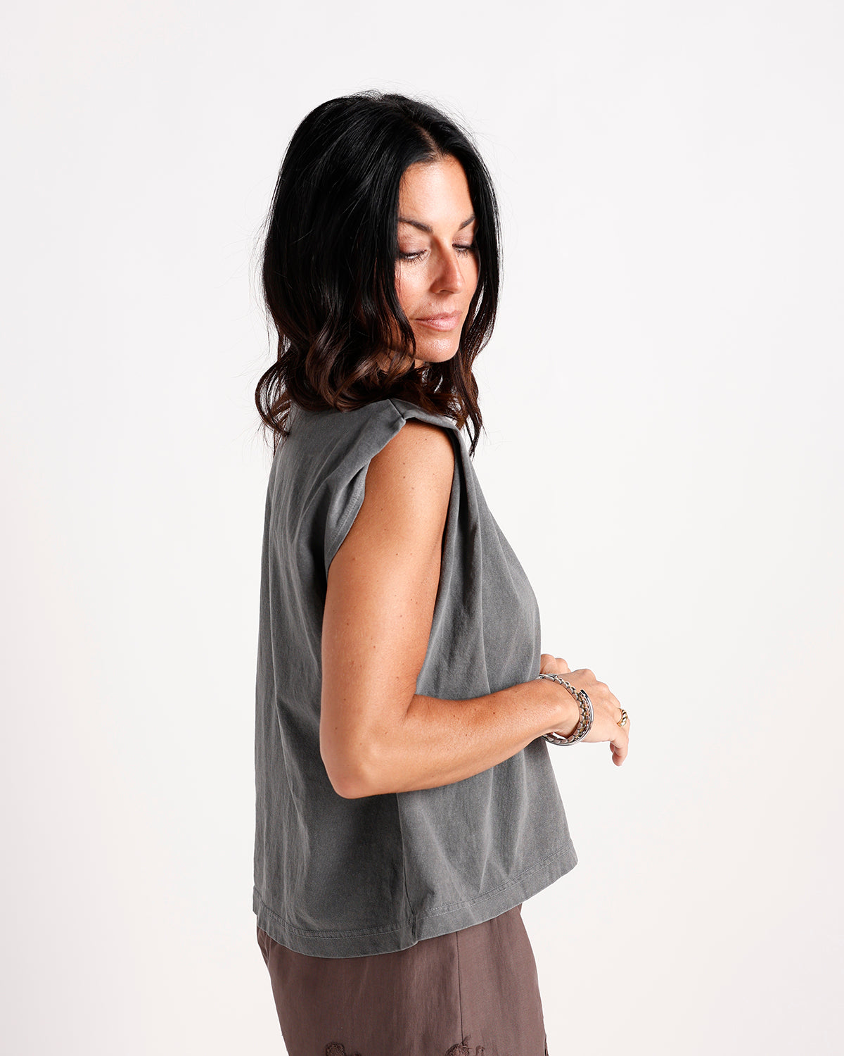Washed gray sleeveless muscle tee with structured shoulders, side profile view.
