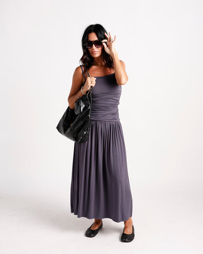 Charcoal gray ruched maxi dress with flowy skirt, worn with black ballet flats