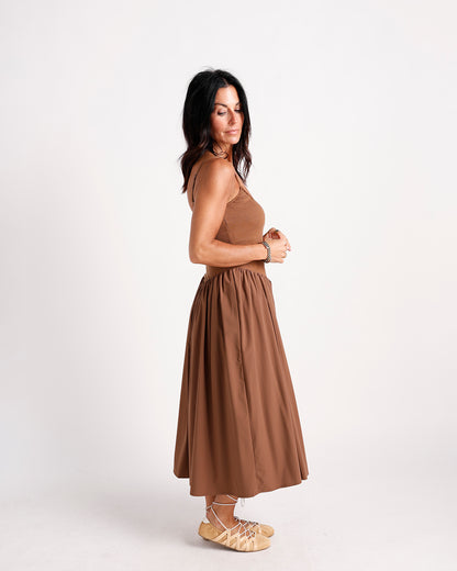 Brown drop waist midi dress with ribbed bodice, full skirt, and thin straps