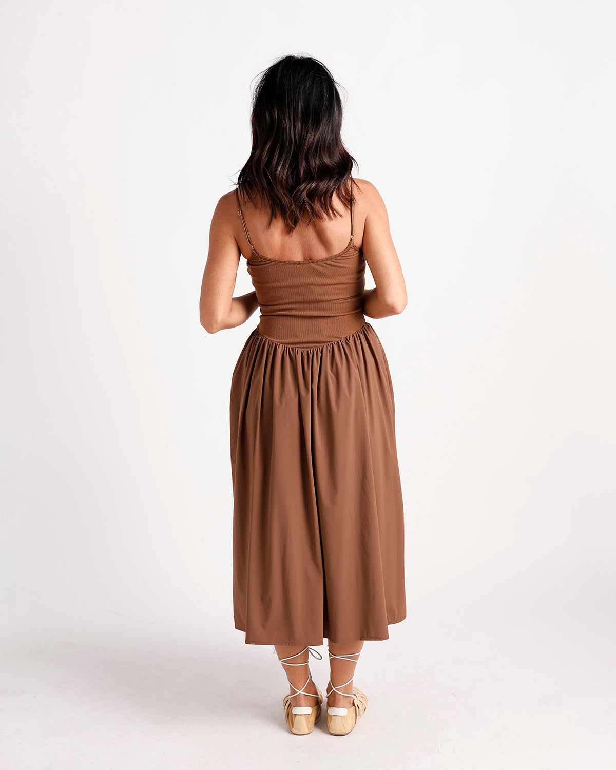 Brown drop waist midi dress with spaghetti straps, ribbed bodice, and full skirt