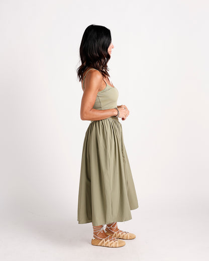 Olive drop waist midi dress with ribbed bodice, full skirt, worn with lace-up sandals
