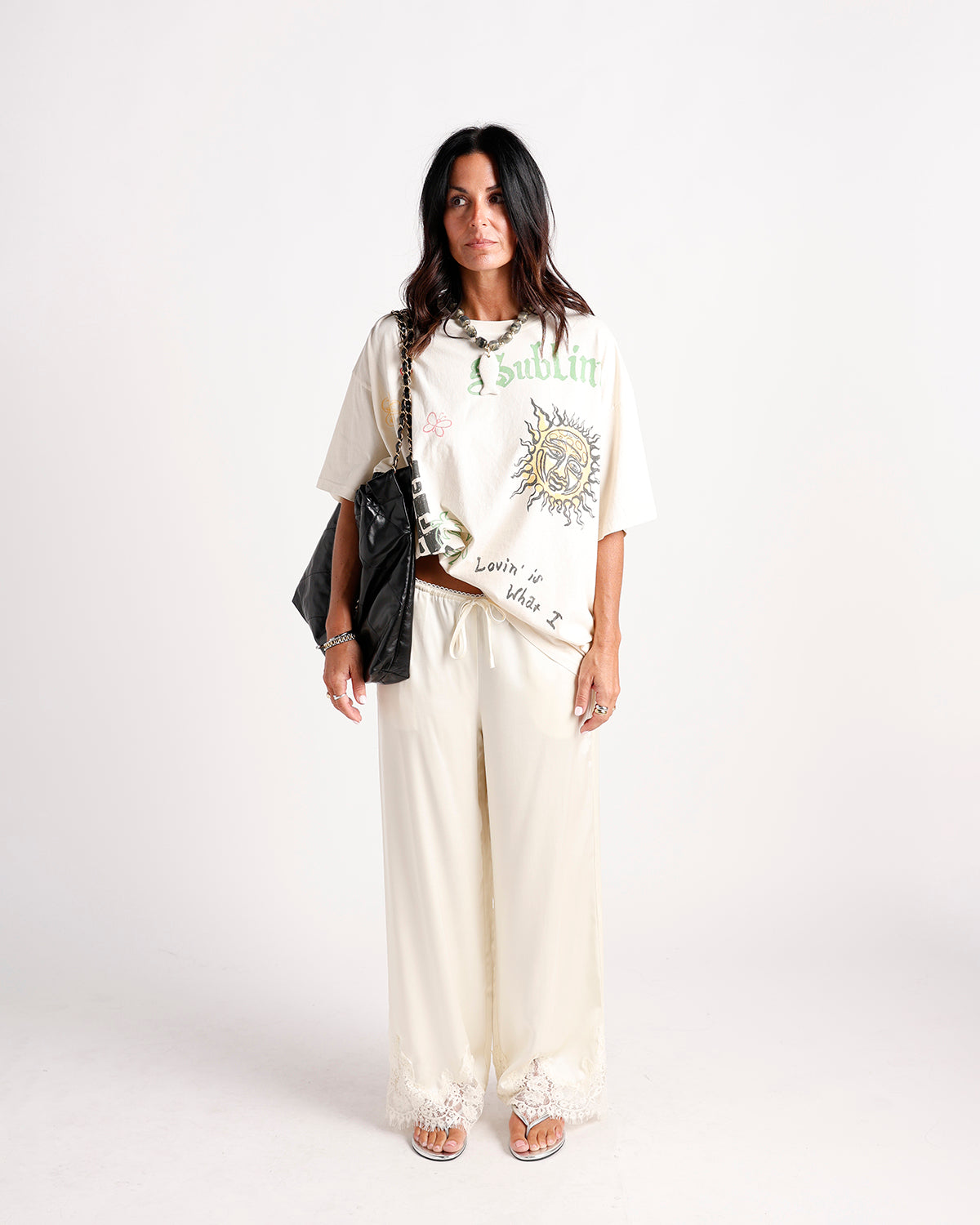Cream wide-leg pants with lace hem trim and drawstring waist