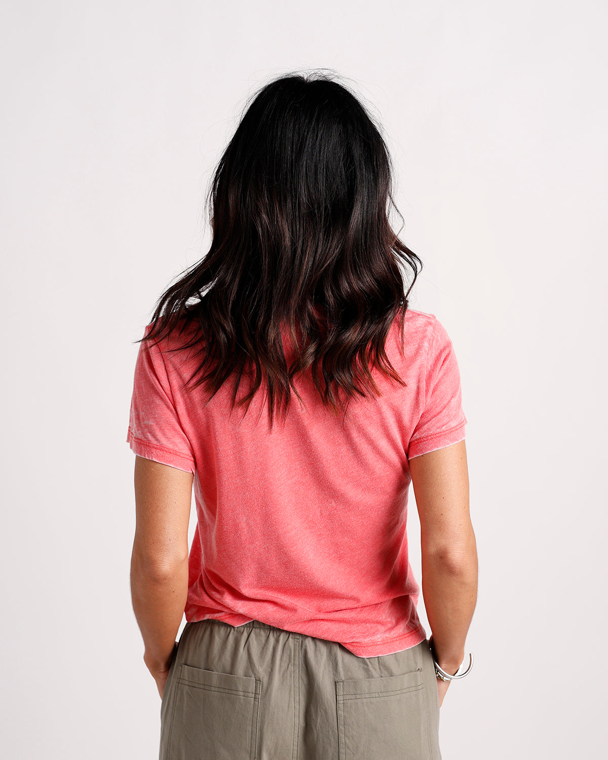 Washed coral red short sleeve tee, back view, worn with olive pants