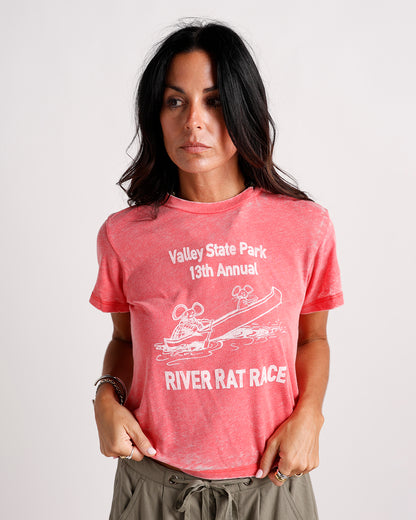 Washed red graphic tee with River Rat Race print, worn by dark-haired woman