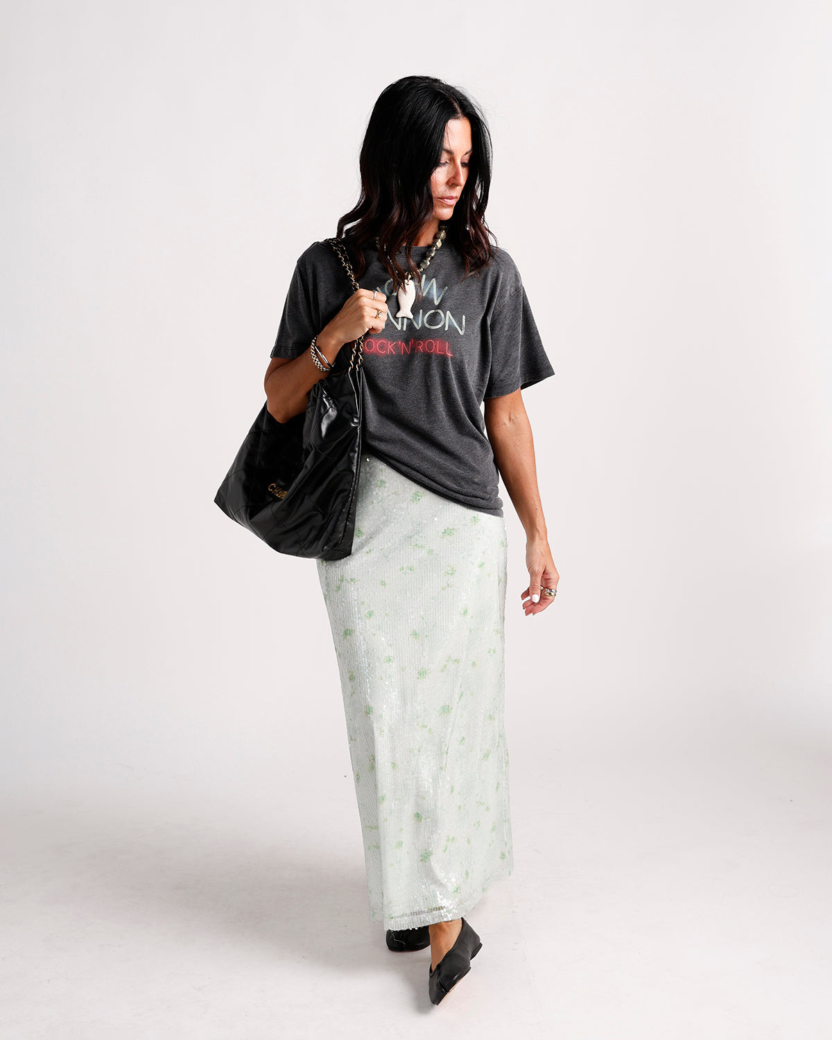 Charcoal gray rock n roll graphic tee worn with white sequin maxi skirt
