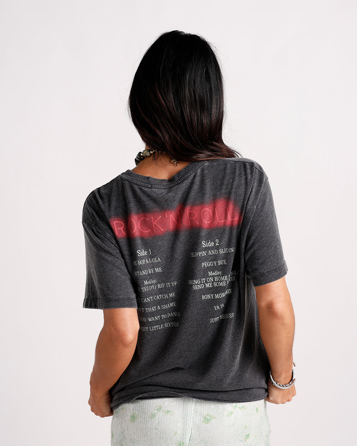 Dark gray graphic tee back view with red Rock N Roll print and song list