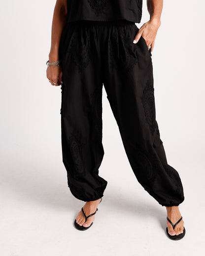 Black embroidered harem pants with elastic waist and gathered ankles