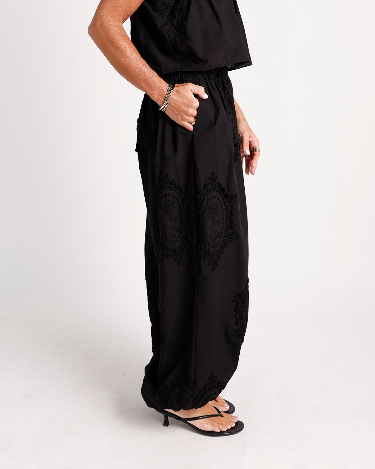 Black wide-leg dressy pants with embroidered mandala pattern and elastic waist