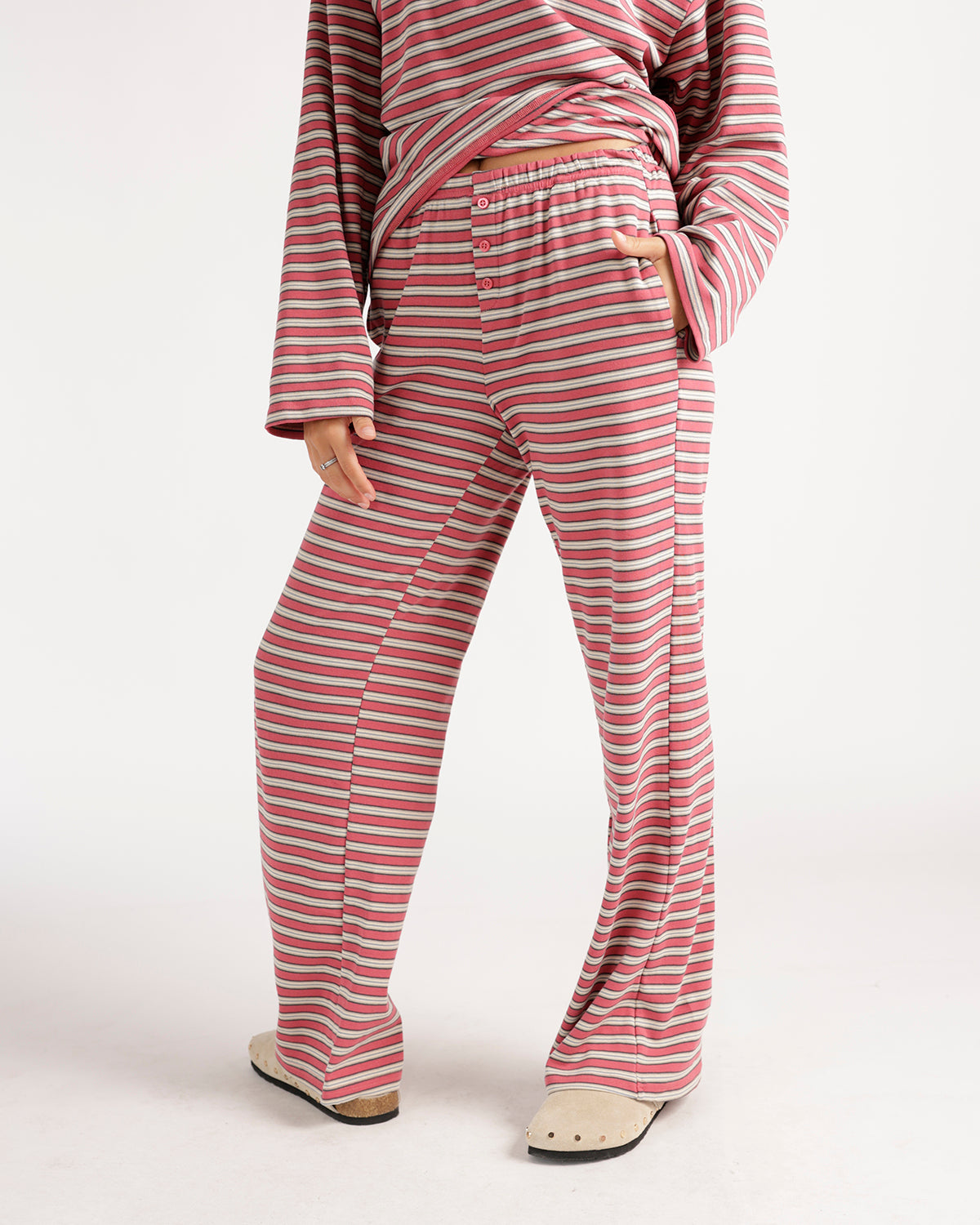 Pink striped lounge pants with elastic waistband, button fly, and wide leg fit.