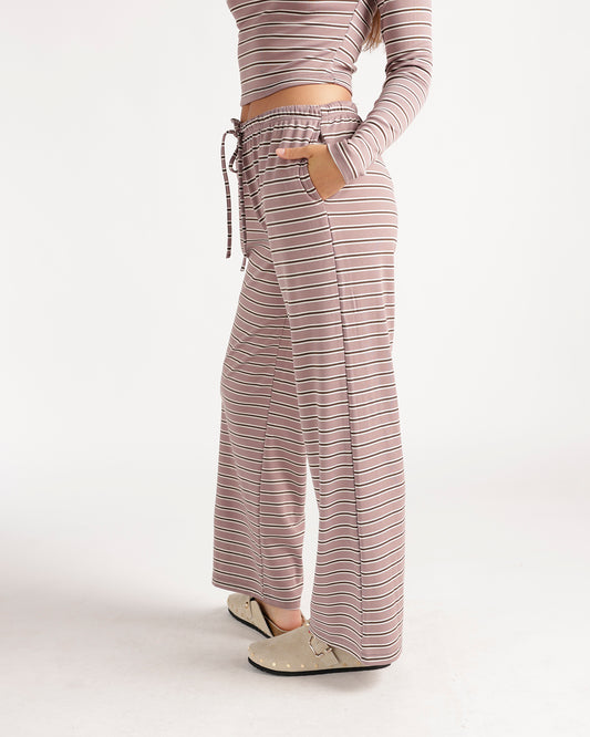 Relax in effortless style with these mauve striped wide-leg pants featuring a comfortable drawstring waistband, flowy silhouette, and retro-inspired stripe pattern. Perfect as a matching set or styled with your favorite basics for a cozy, chic look made for weekends, lounging, and everyday wear.