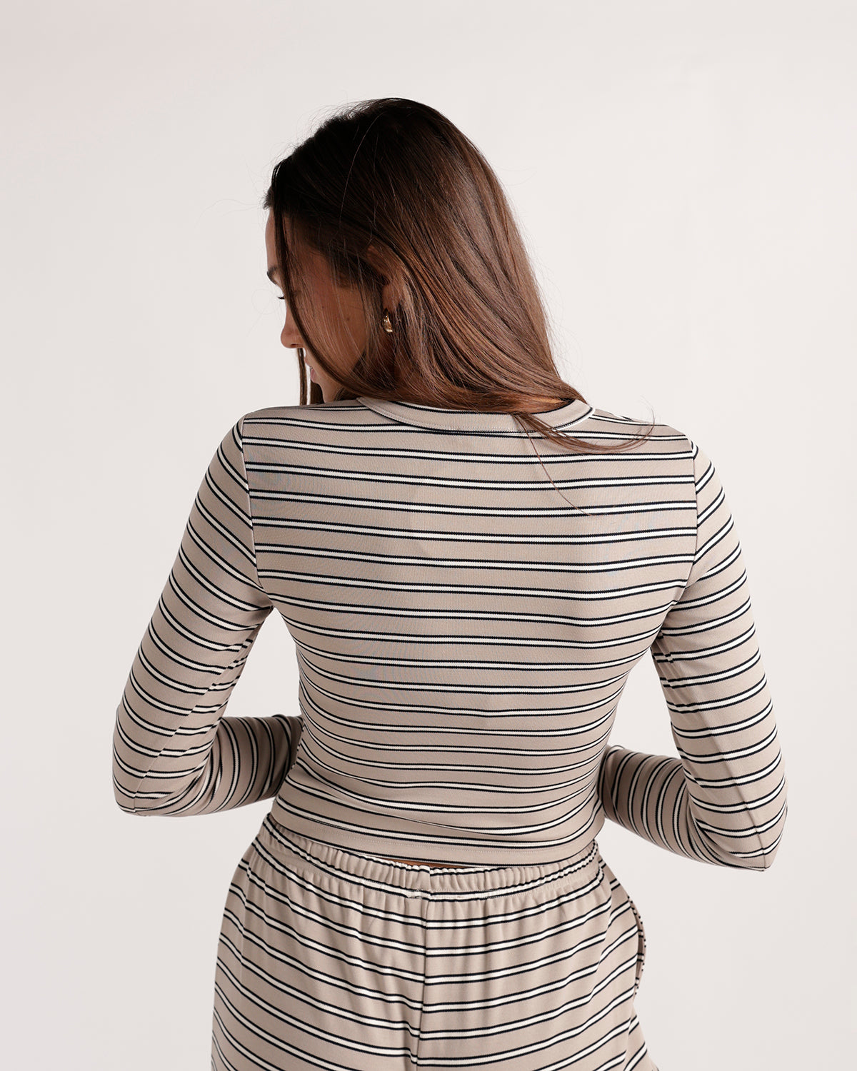 Beige and black striped long sleeve fitted top, back view
