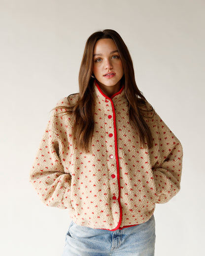 All over red heart printed brown sherpa jacket with red trim