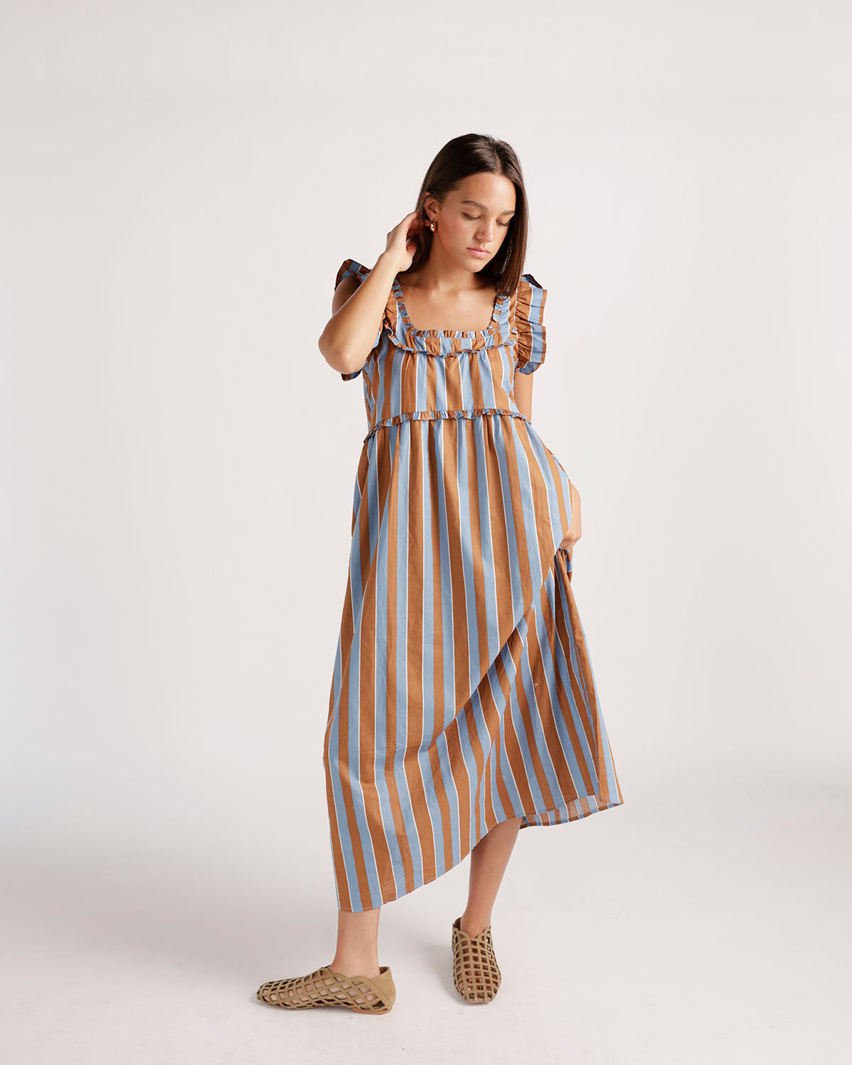 Striped brown and blue ruffle-neck midi dress with flutter sleeves and woven flats