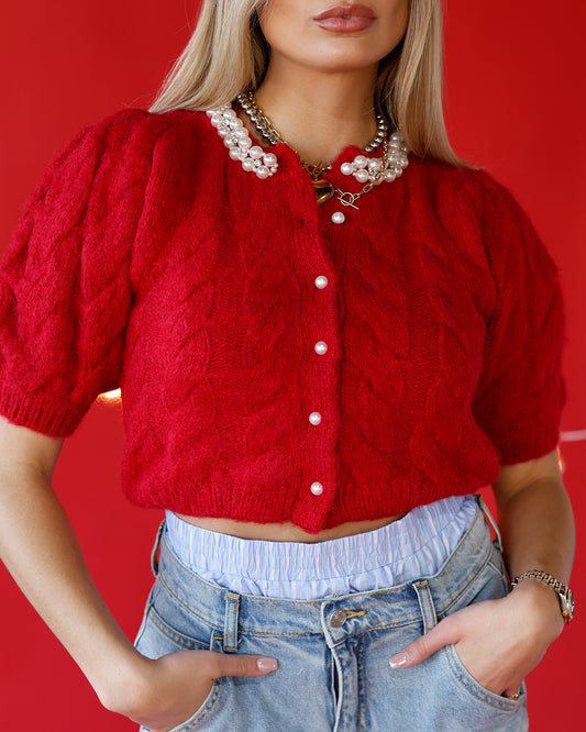 red holiday cardigan pearls holiday party outfit ideas