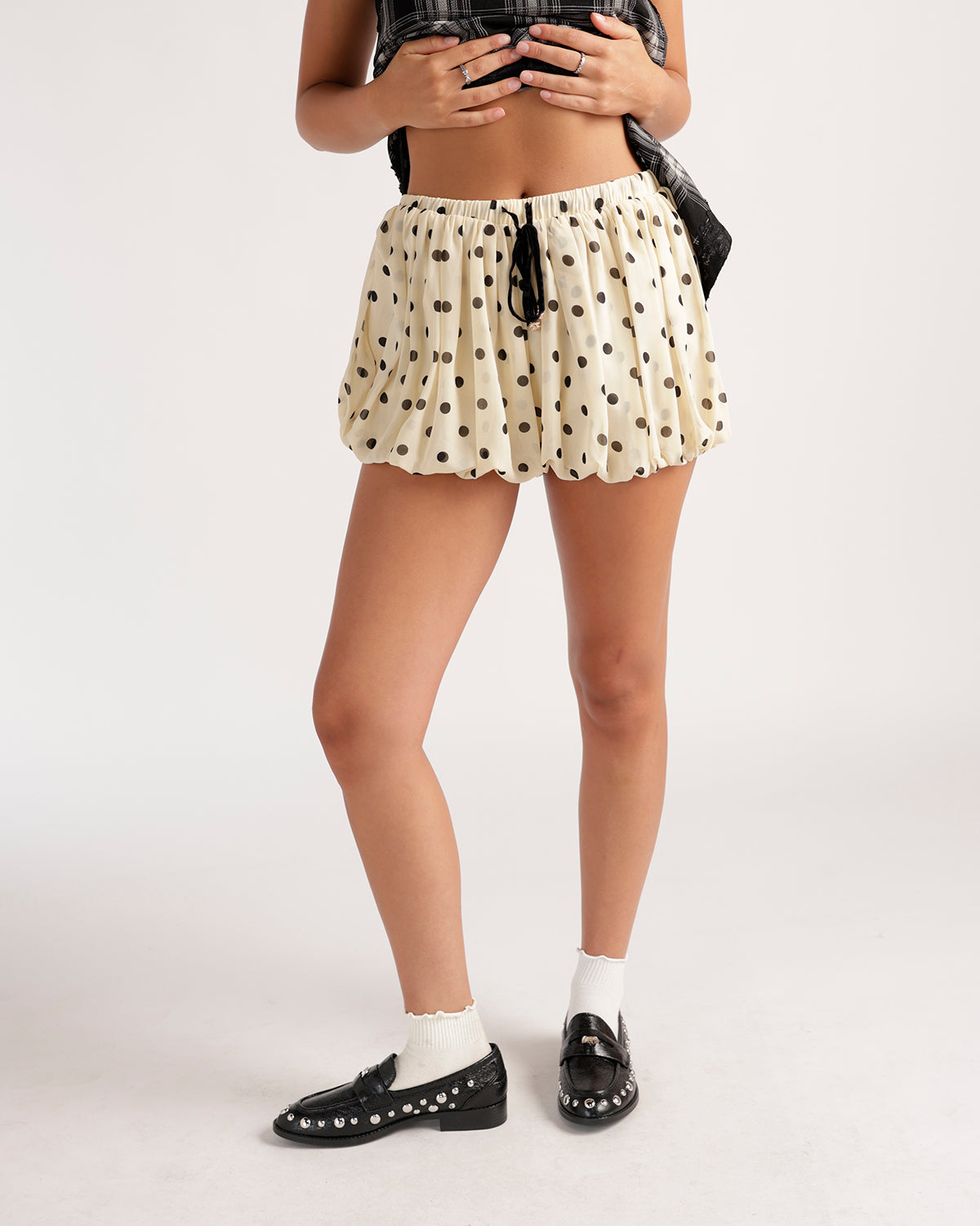 Cream polka dot bubble skort with elastic waistband and drawstring tie detail.
