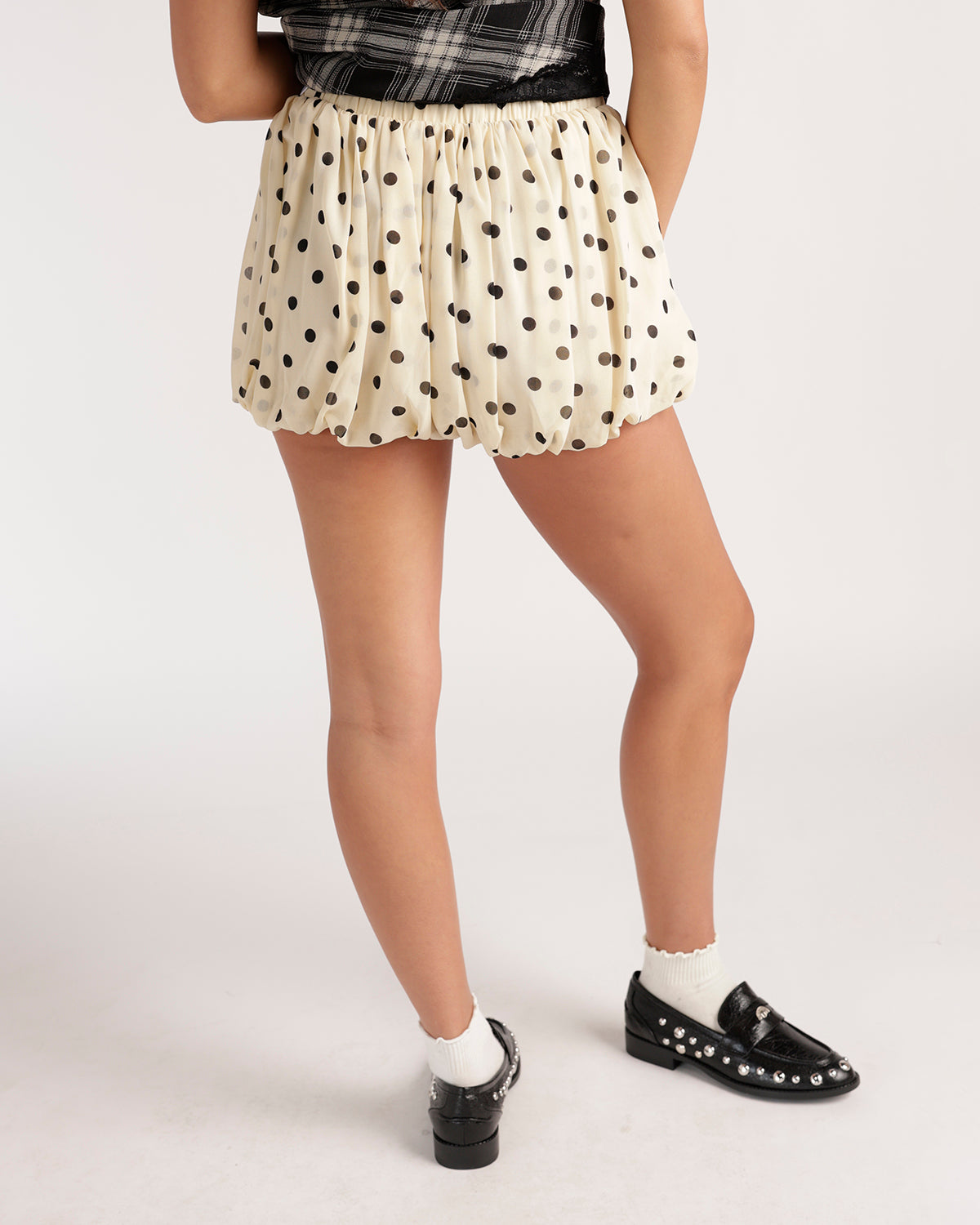 Cream polka dot bubble skort with elastic waist, worn with black studded loafers