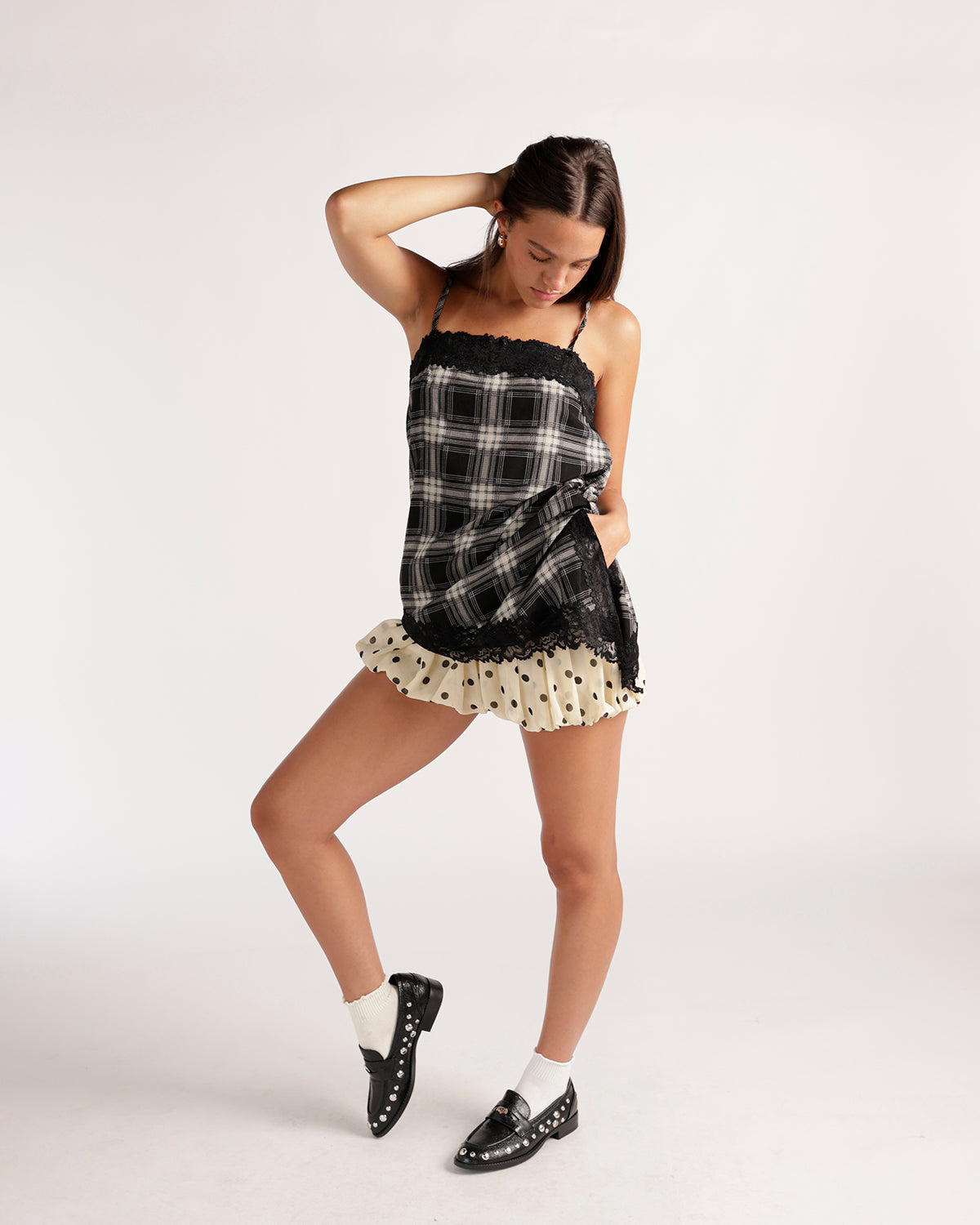 Cream bubble skort with brown polka dots and ruffled hem, styled with plaid top