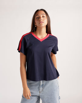 Navy blue v-neck tee with red contrast trim and shoulder stripes, short sleeves