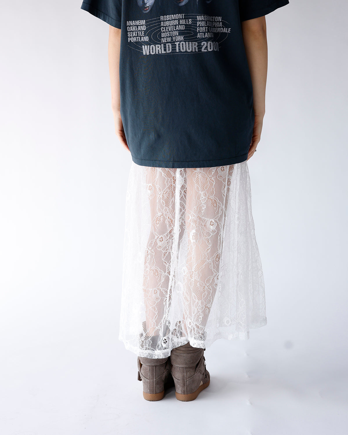 White floral lace maxi skirt styled with dark band tee and gray boots