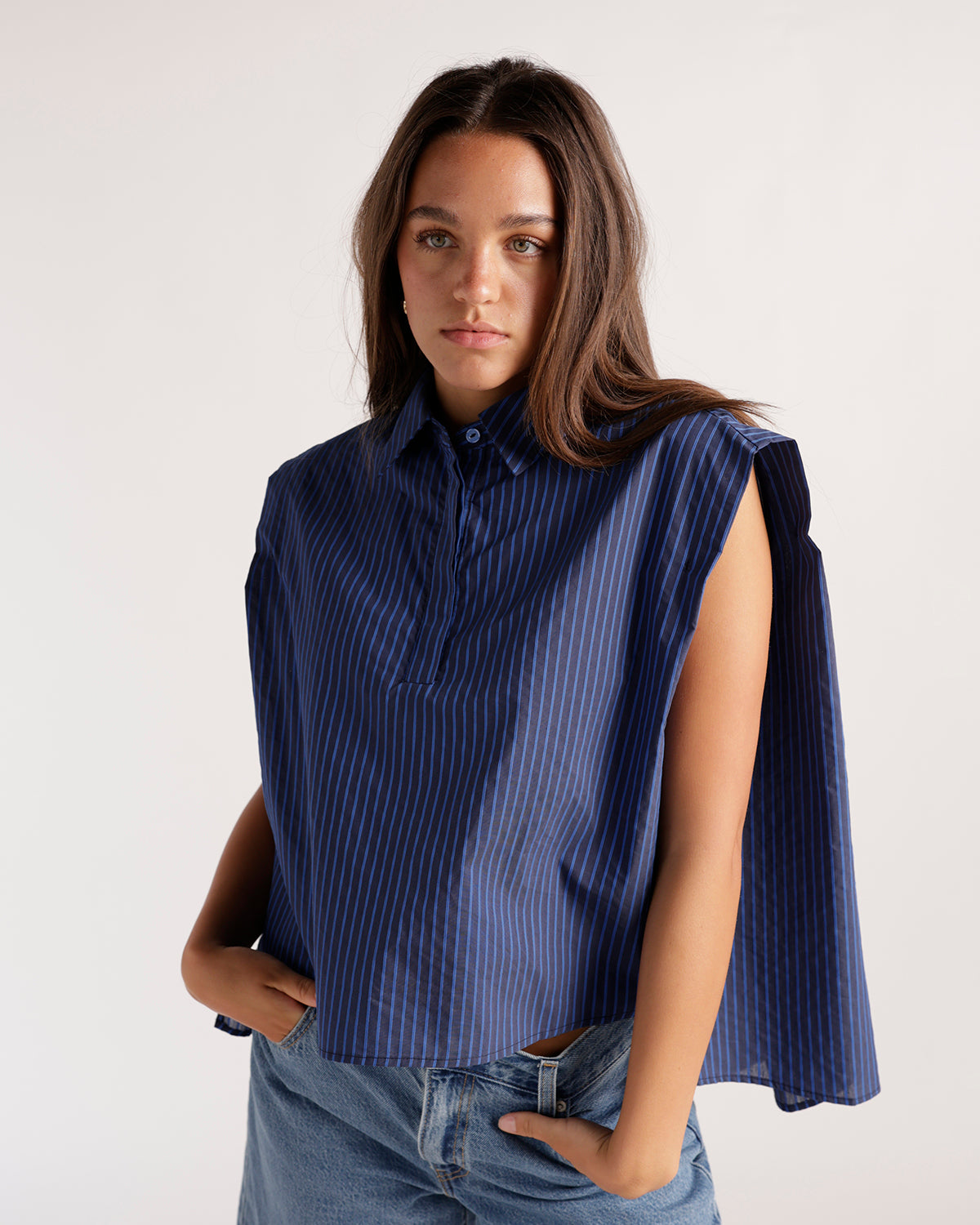 Navy blue pinstripe sleeveless cropped shirt with collar and half-button placket