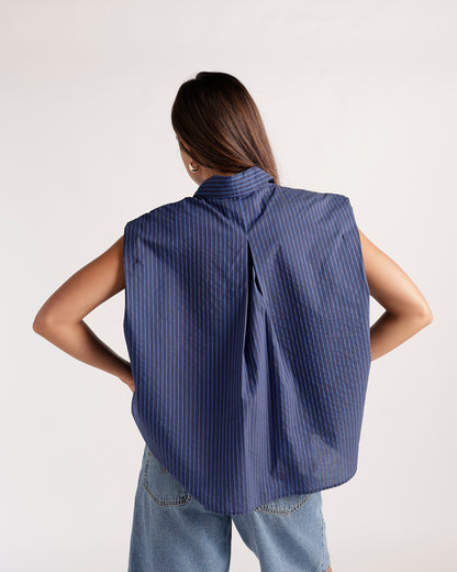 Sleeveless navy blue pinstripe button-up top with structured shoulders, back view