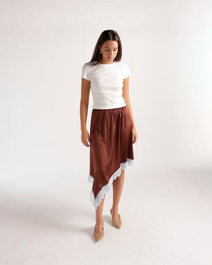 Brown satin asymmetric midi skirt with white lace trim, styled with white tee