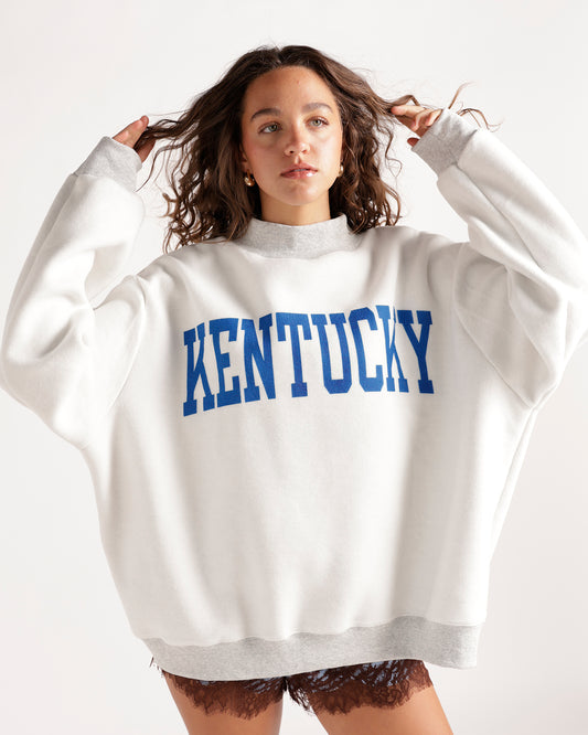 Get cozy with this stylish gray mockneck sweatshirt featuring a bold 'God Bless KY' print with reversible "kentucky" bold print on the other side. Perfect for casual wear.