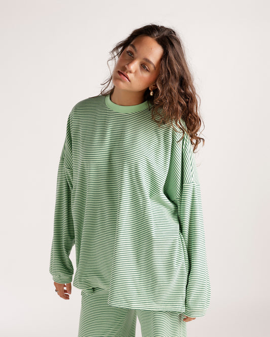 Oversized green striped long sleeve top with crew neck and relaxed fit