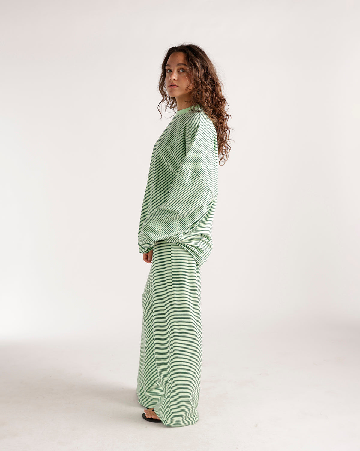Oversized green and white striped long sleeve top with relaxed fit
