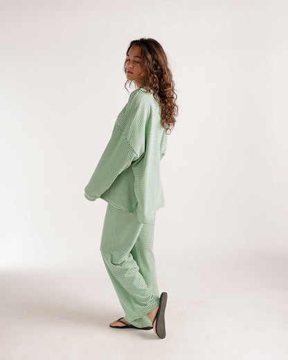 Oversized green and white striped long-sleeve top with relaxed fit, back view