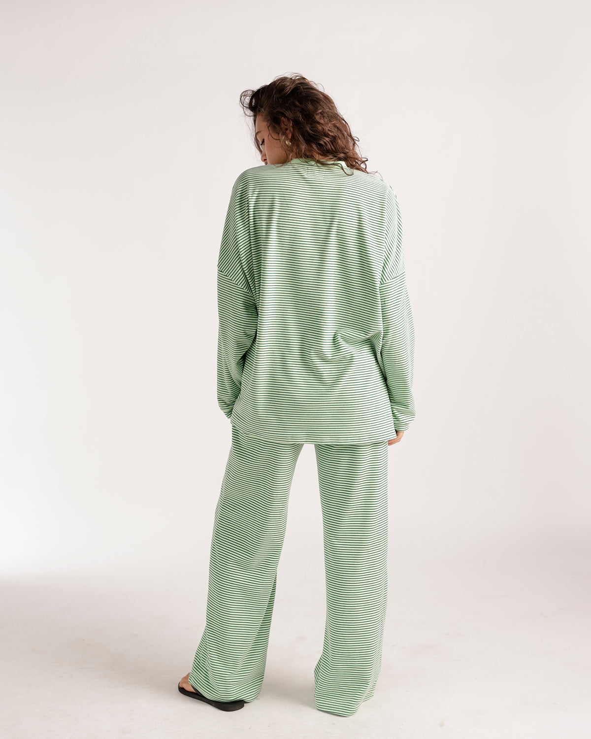Oversized green and white striped long sleeve top, relaxed fit, back view