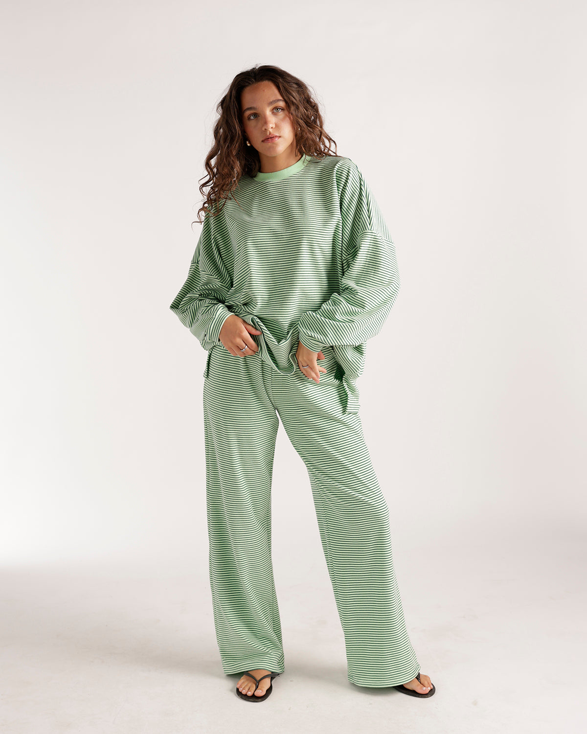 Oversized green and white striped long sleeve crew neck top with relaxed fit