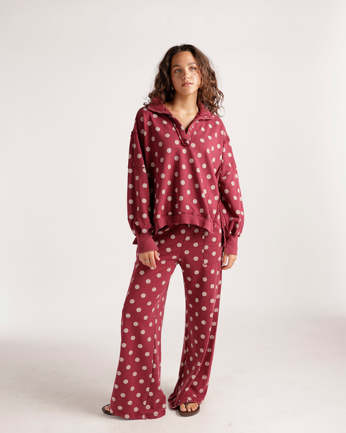 Oversized burgundy polka dot pullover sweatshirt with collar and lace-up side details
