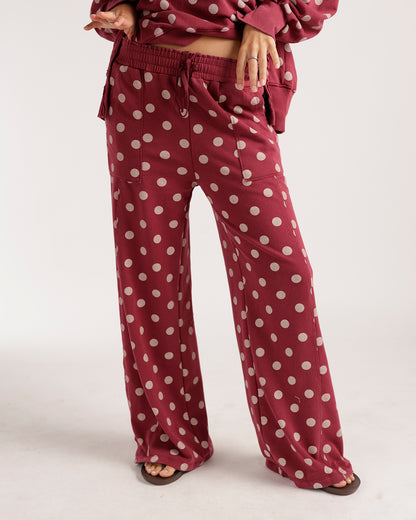 Wide-leg burgundy lounge pants with large cream polka dots and drawstring waist