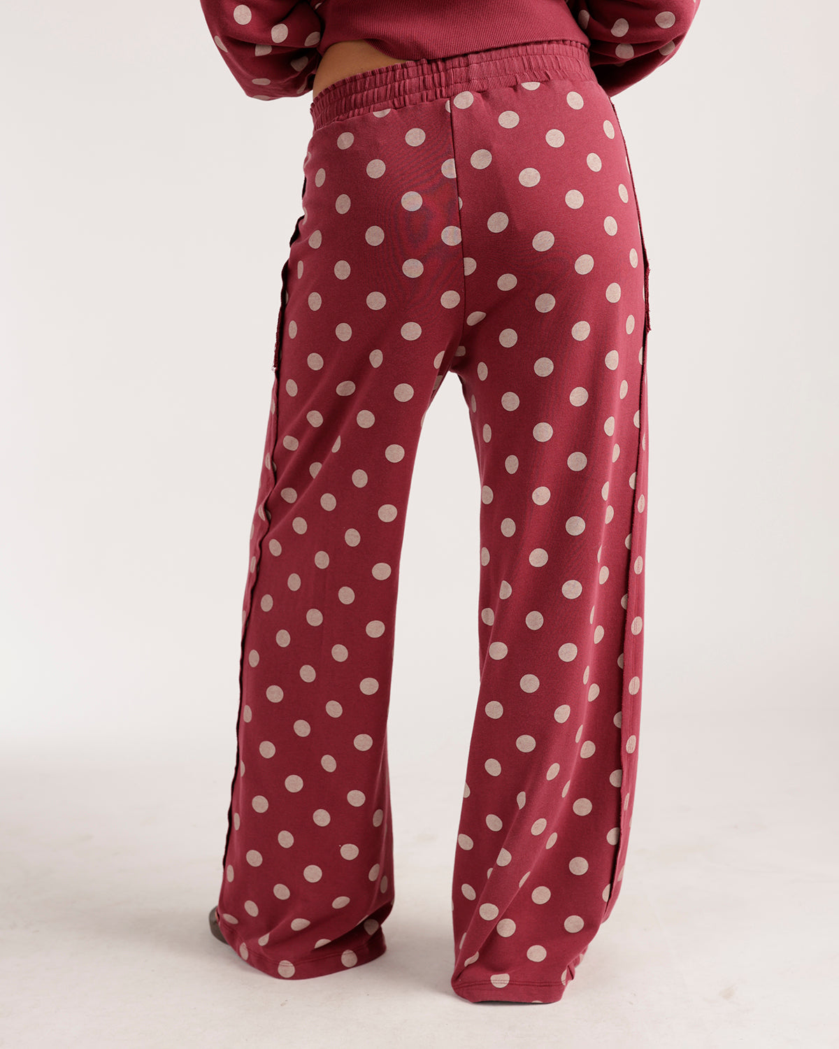 Berry red wide-leg lounge pants with white polka dots and elastic waistband