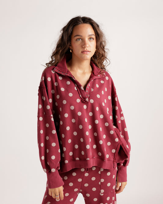 Stay cozy in this burgundy polka dot pullover featuring blush pink dots, a silver snap-button collar, and a relaxed cropped fit. Perfect for pairing with jeans or joggers, this effortlessly cute sweatshirt is ideal for casual weekends, brunch dates, and everyday layering.